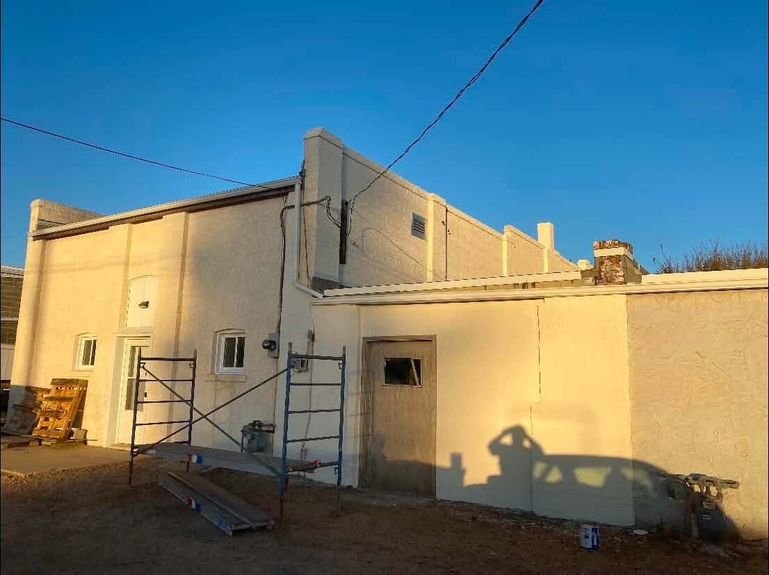After: the same stucco exterior in a clean cream finish