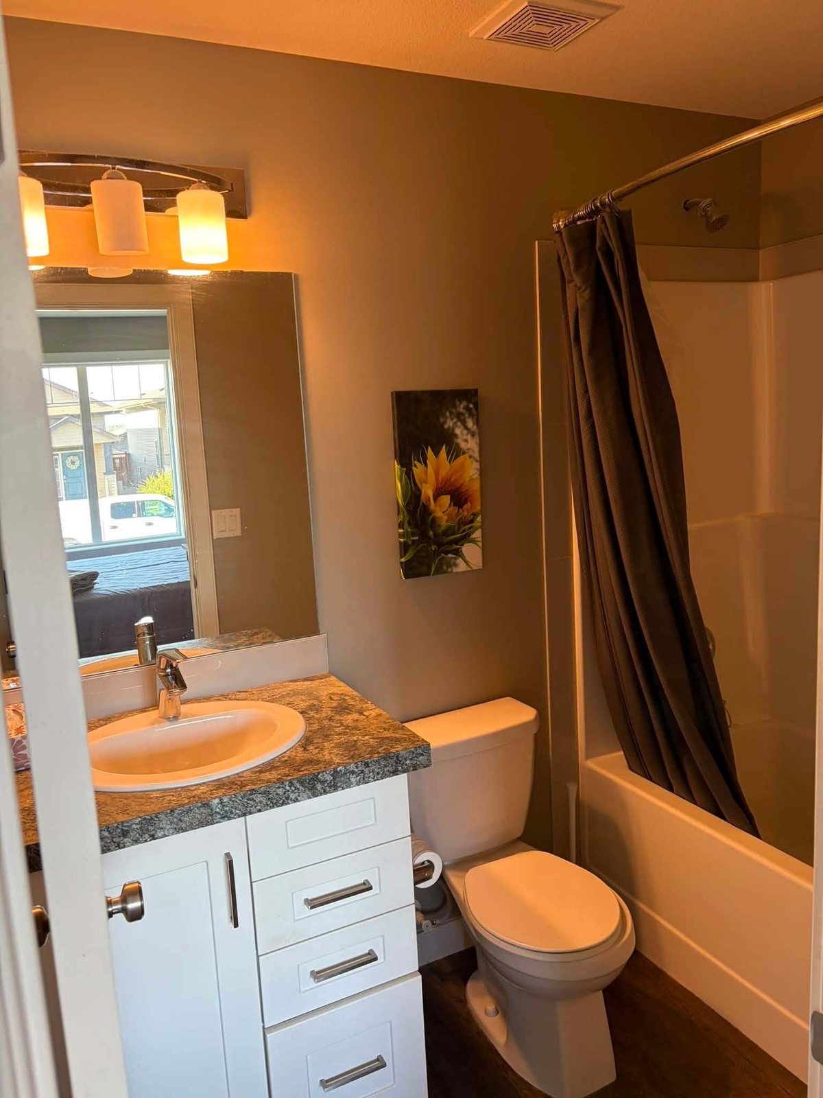 Bathroom with a tan vanity and freshly painted walls