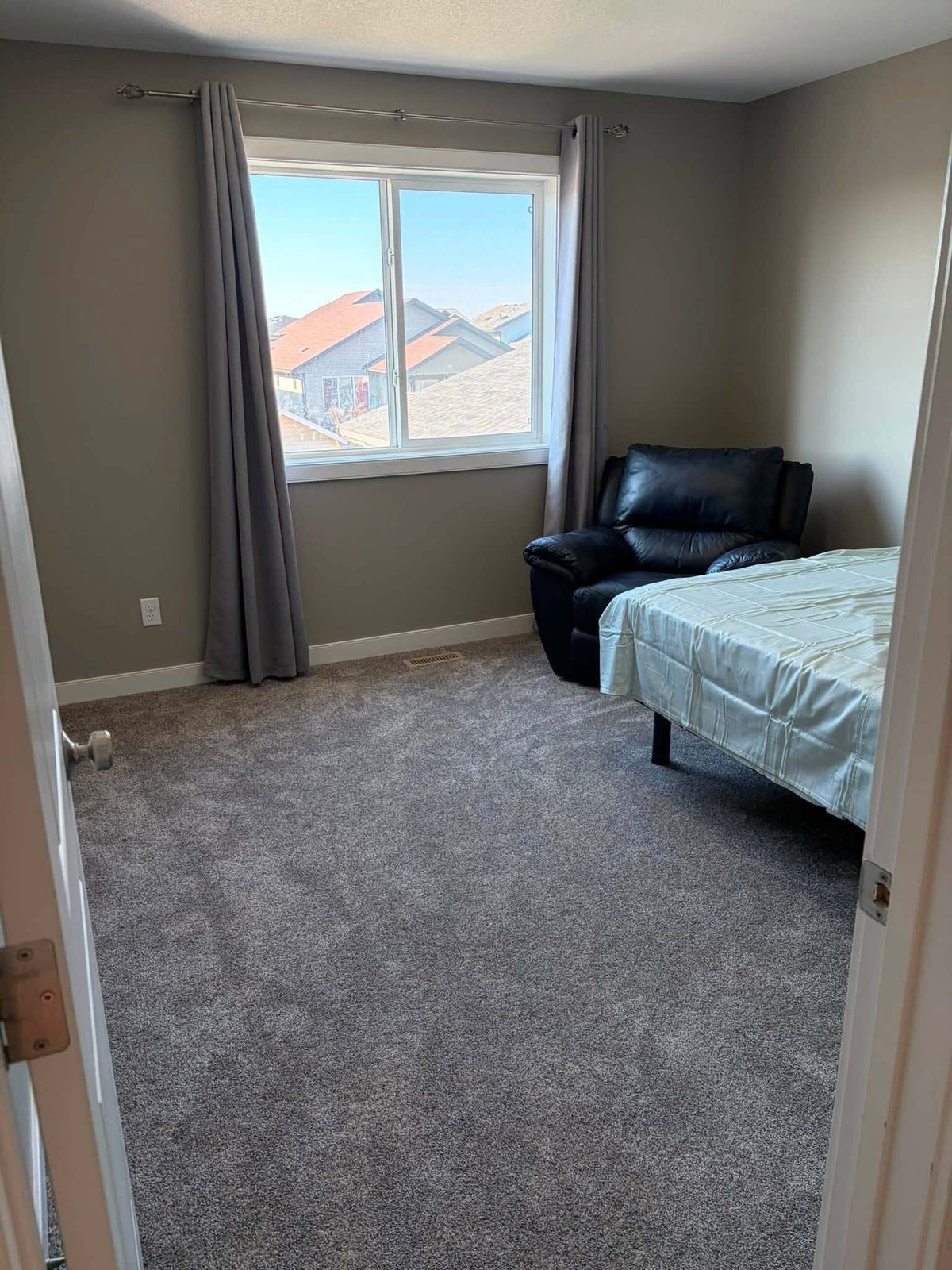 Bedroom reading corner with an armchair and fresh wall paint