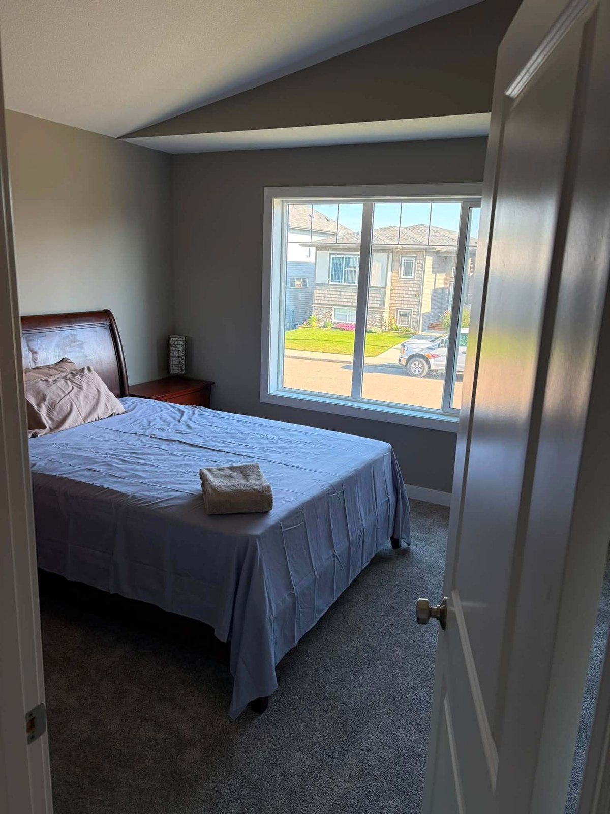 Bedroom with a sleigh bed and fresh neutral wall paint