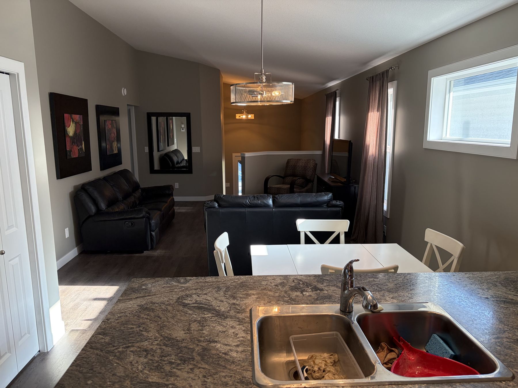 Kitchen island looking through to the dining and living area, walls freshly painted