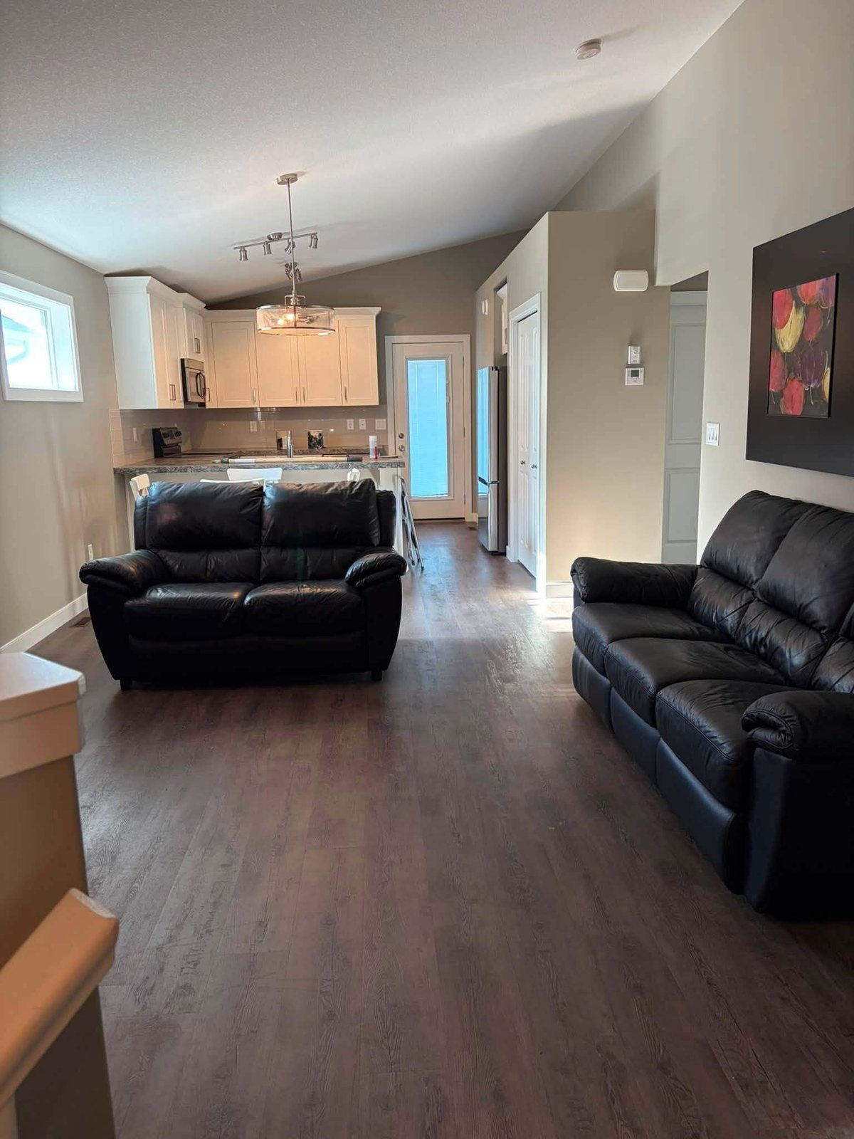 Freshly painted living room seen from the hallway of a furnished home