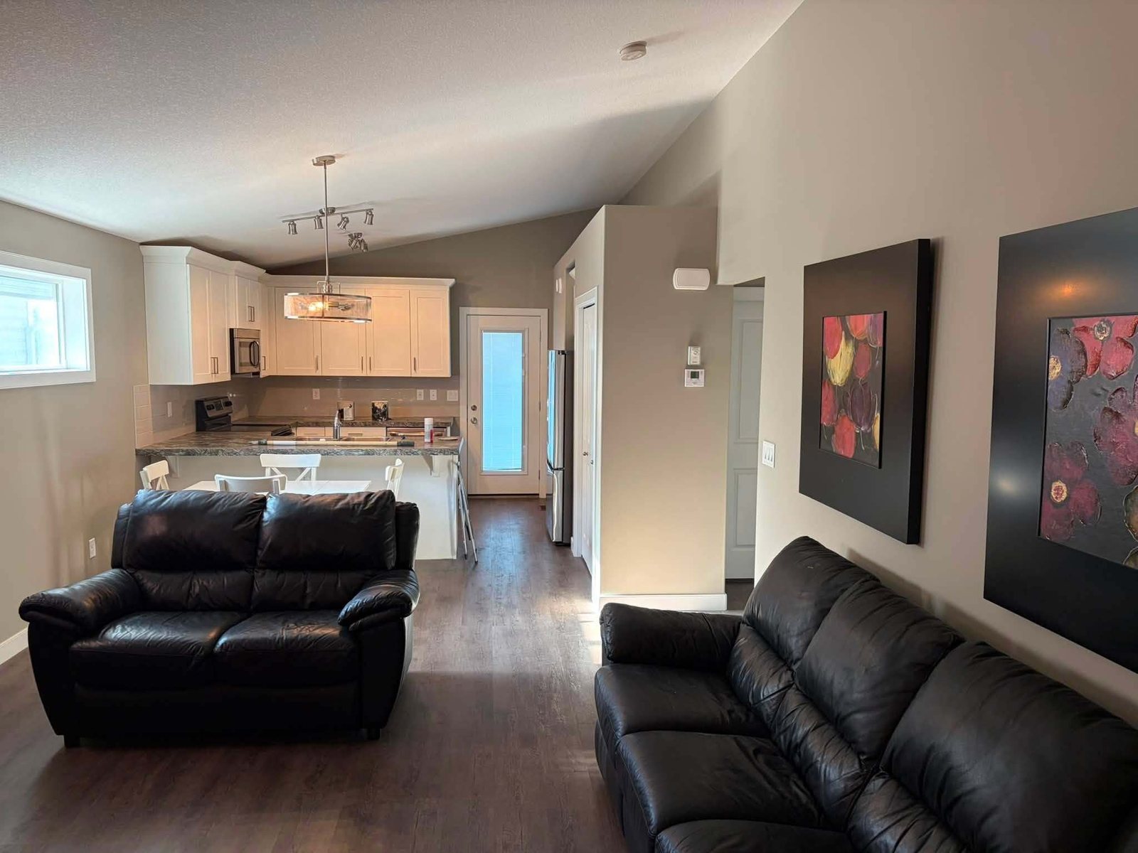 Open-plan living room and kitchen with freshly painted walls in a Red Deer area home
